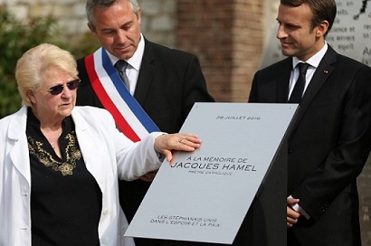 Pappi Hamelin sisko, pormestari ja pres Macron olivat 1v muistotilaisuudessa  papille tehdyn muistokyltin vieressä.jpg