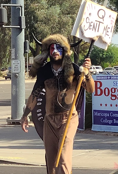 Jake_Angeli_(Qanon_Shaman),_seen_holding_a_Qanon_sign_(cropped).jpg