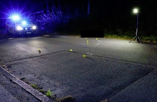 Poliisi tutki surmapaikkaa. Keltaisten merkkauslaattojen vierellä näkyy uhrin vaatteista tulleita raahausjälkiä. Uhri jäi makaamaan mustan laatikon kohdalle. POLIISI