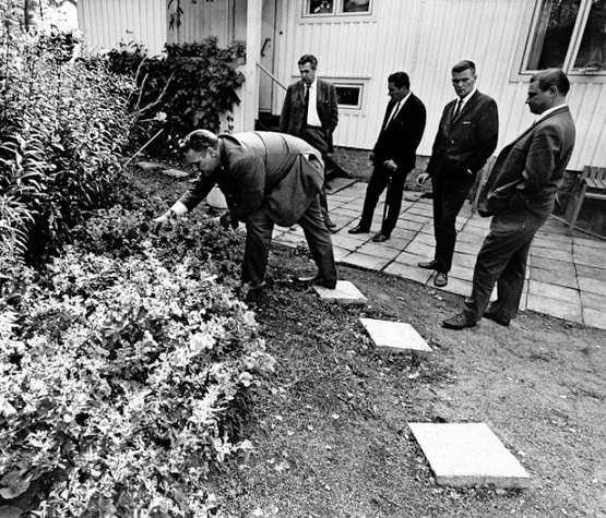 Poliisit tutkivat surmapaikkaa. Kun Aili astui likaämpäri kädessään ulos, surmaaja hyökkäsi väijystä hänen kimppuunsa. Kukkaruukkuakaan ei jätetty pihapiirissä kääntämättä surmaajan jälkien etsimiseksi. Kuva Jarmo Matilainen.